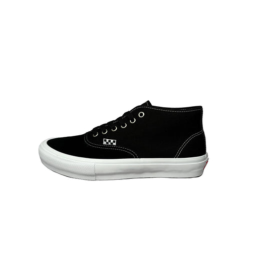 black sneaker with a textured sole on a white background