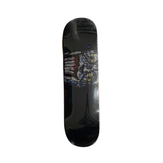Skateboard deck with a joker graphic design on a white surface
