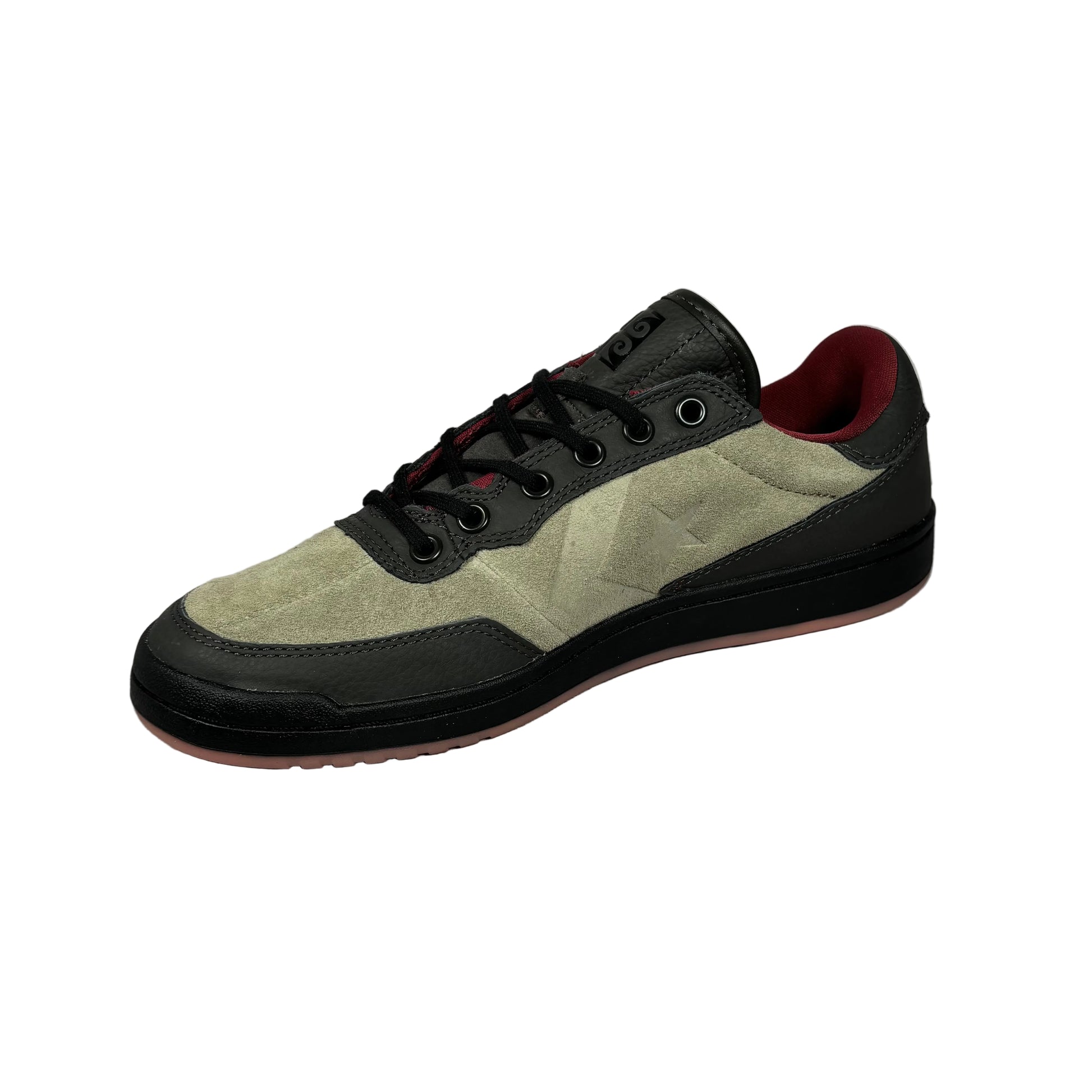 Suede sneaker with black and red accents on a white background