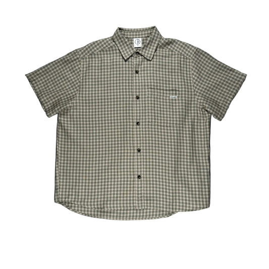 Green and white checkered shirt on a white surface
