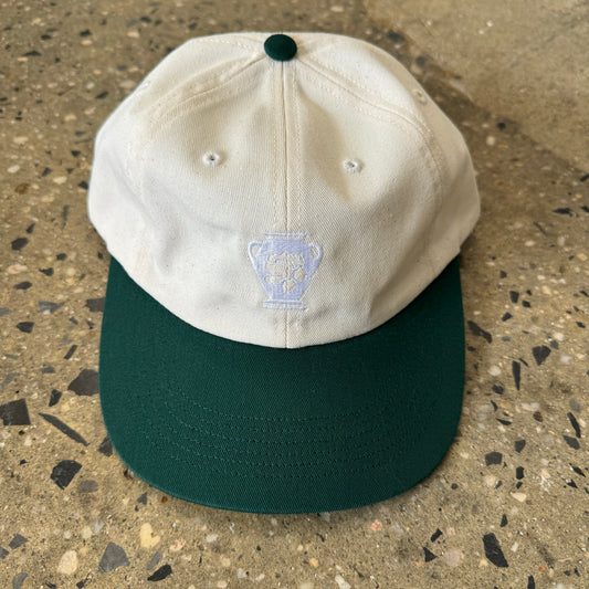 cream hat with green bill