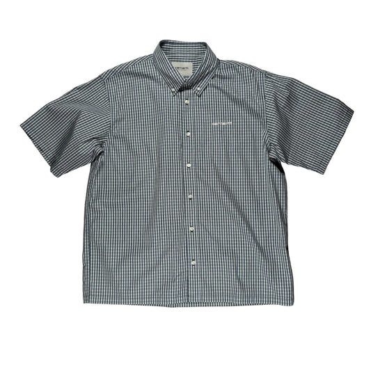Checkered short-sleeve shirt on a white surface