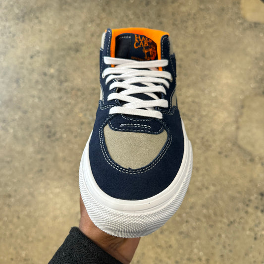 top down view of navy and light grey skateboard shoe with laces and toe box in view, white outsole