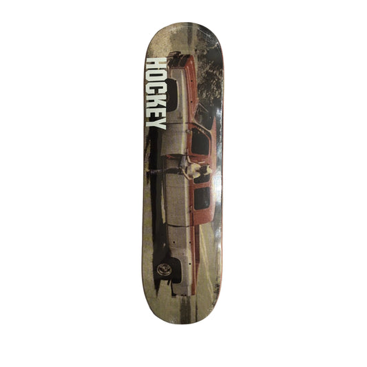 Skateboard deck with vintage car design and 'Hockey' branding on a white surface.