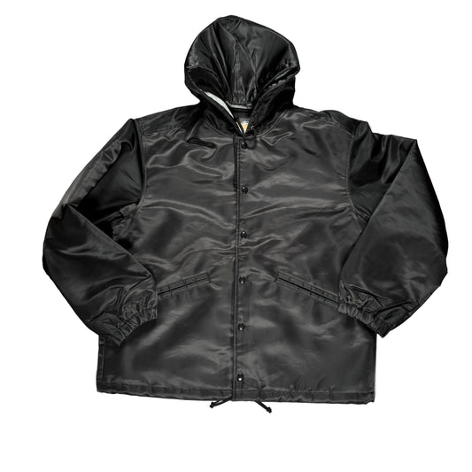 Black jacket with a hood on a gray surface