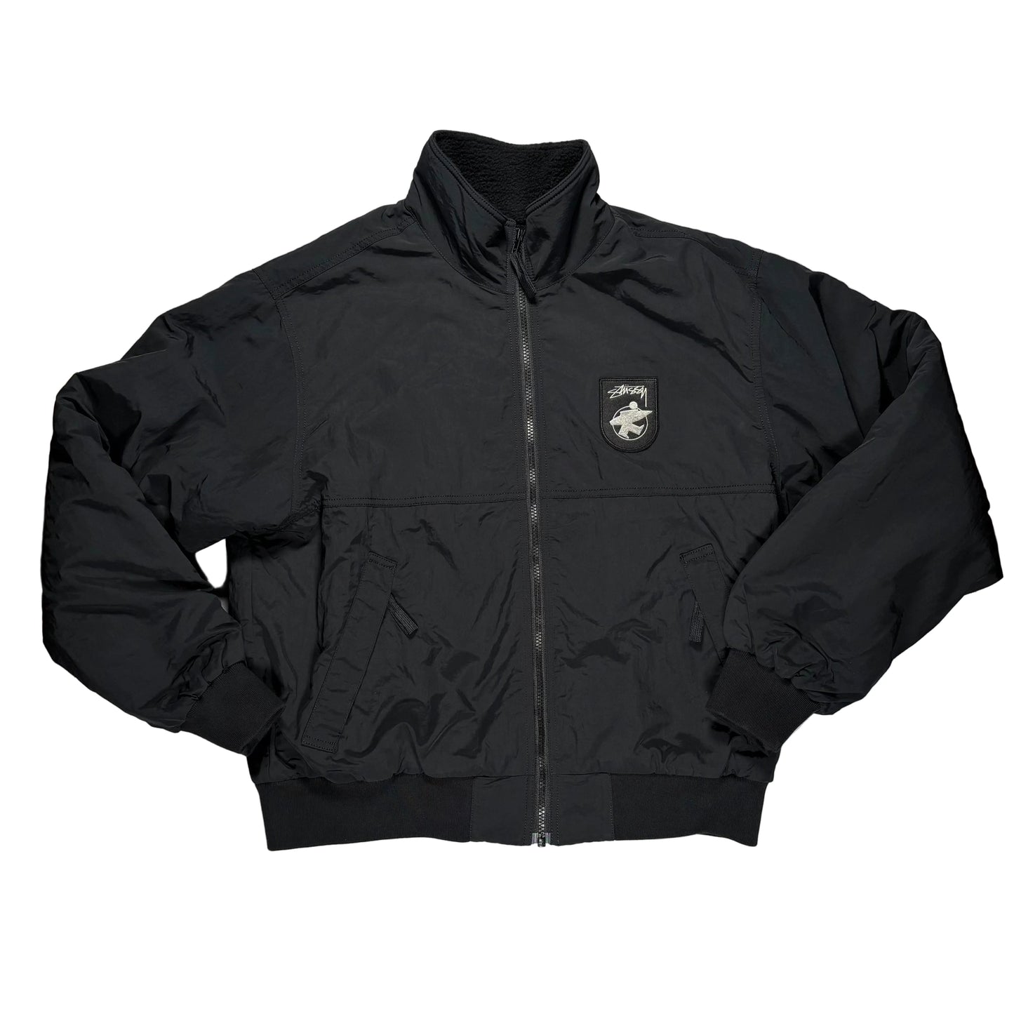 Black jacket with a logo on a gray surface