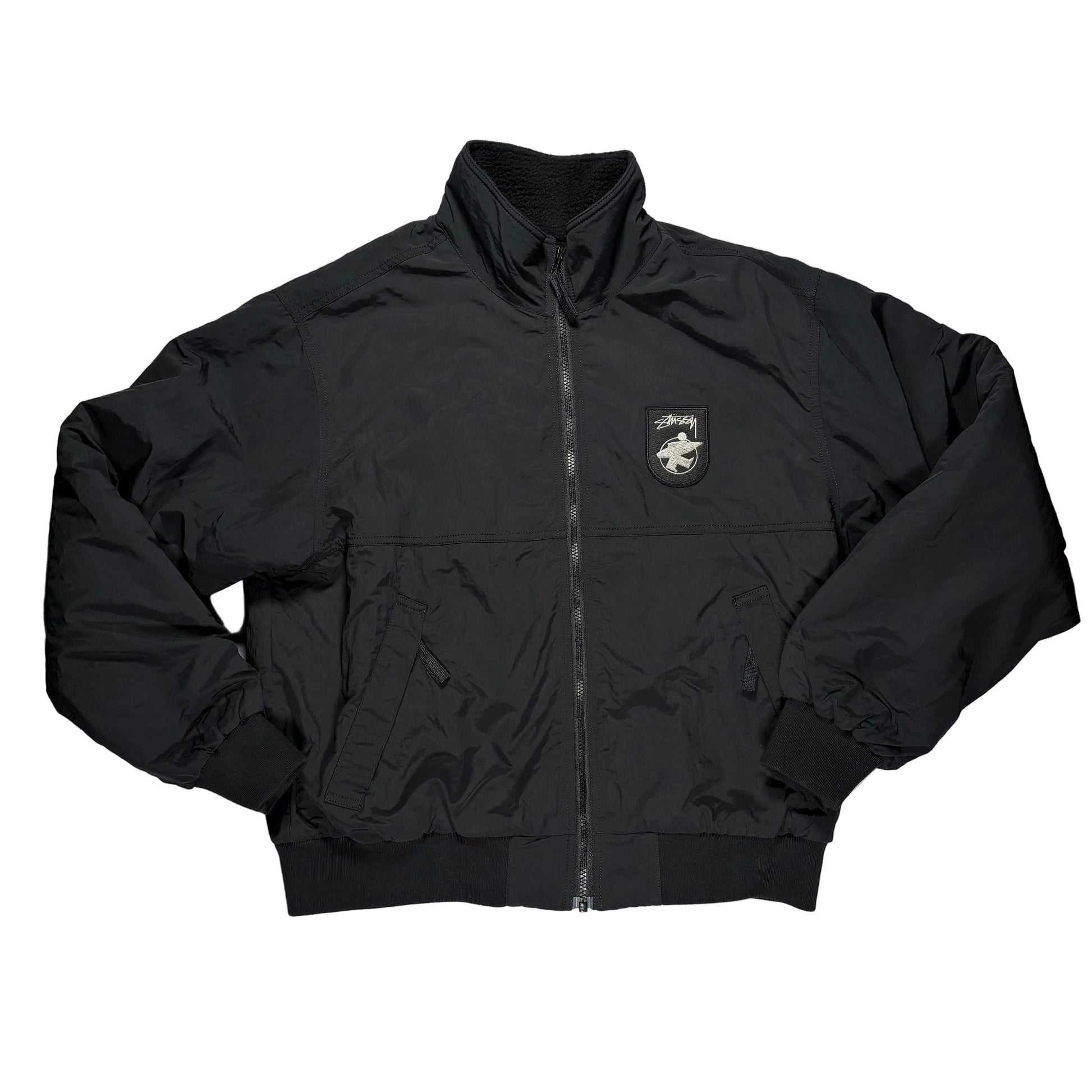 Black jacket with a logo on a gray surface
