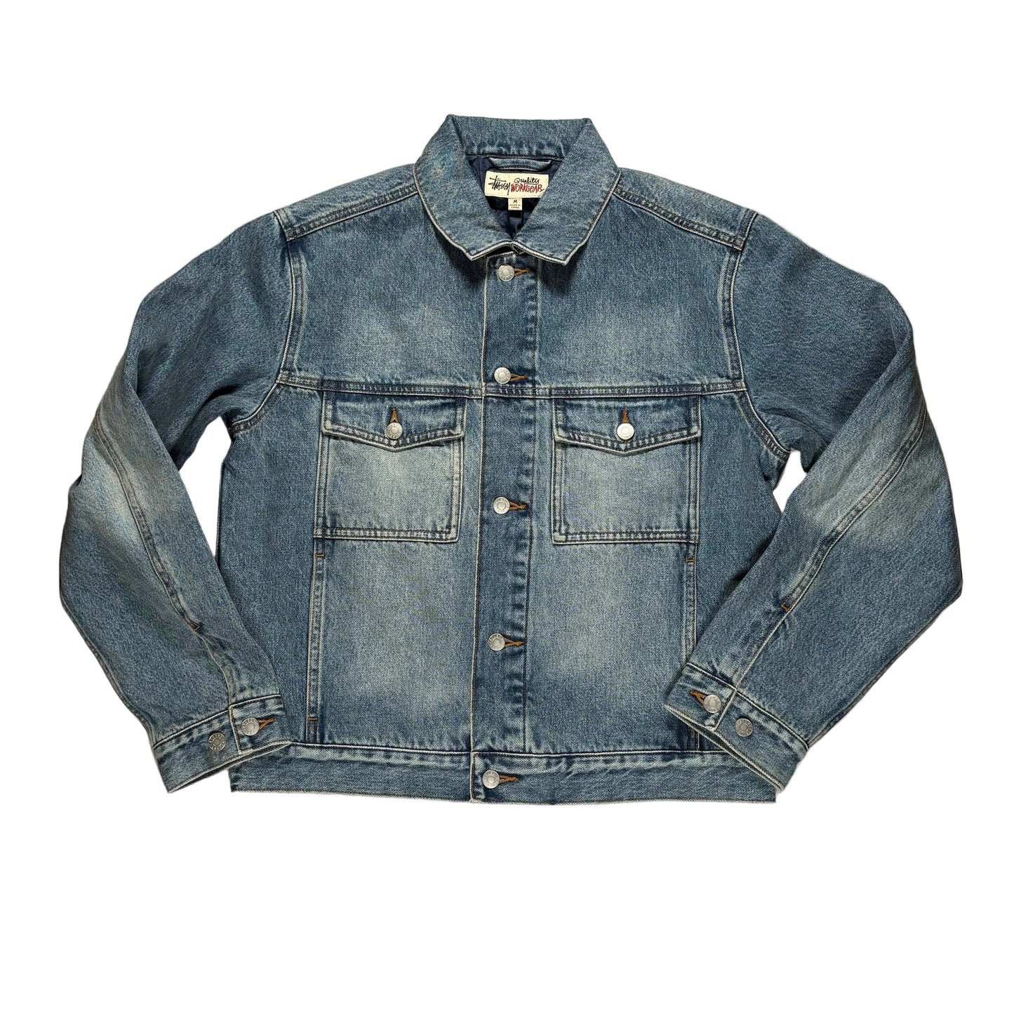Blue denim jacket on a white surface