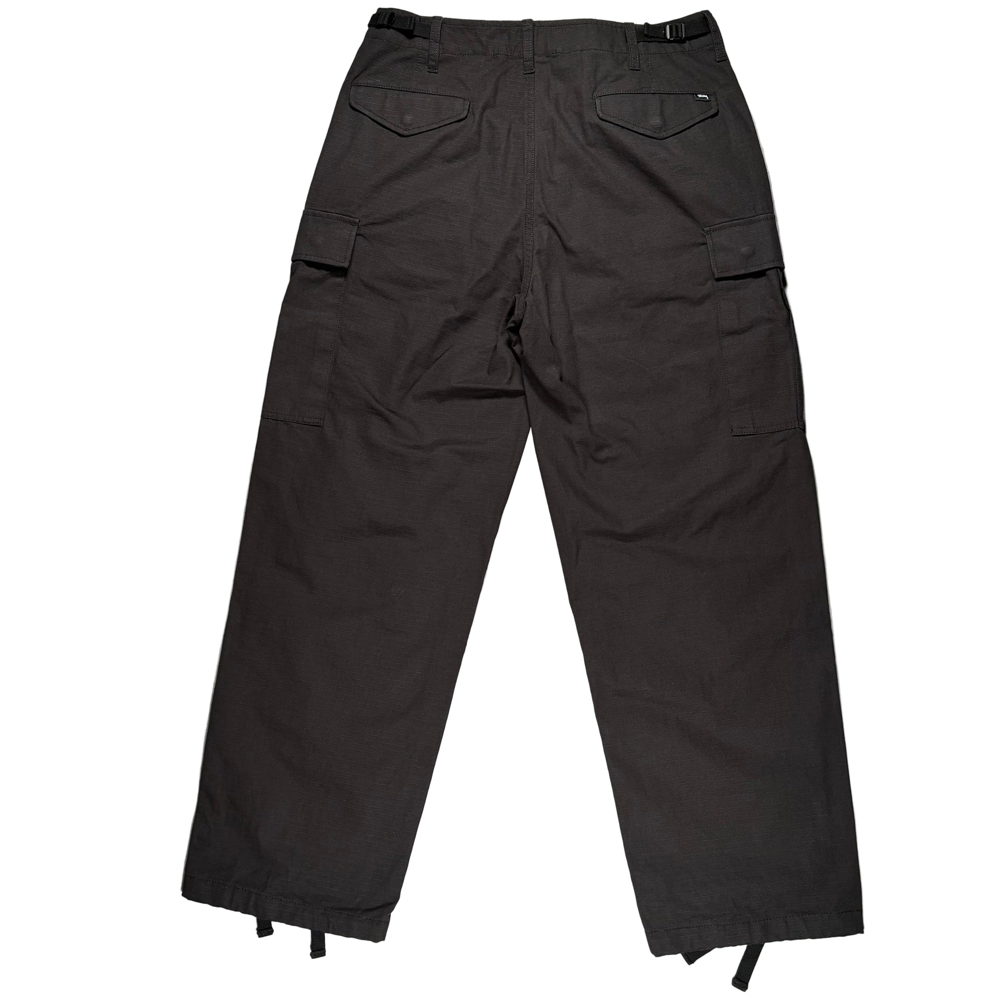 Black cargo pants on a white surface 
