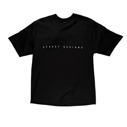 Black t-shirt with 'STUSSY DESIGNS' text on a white surface