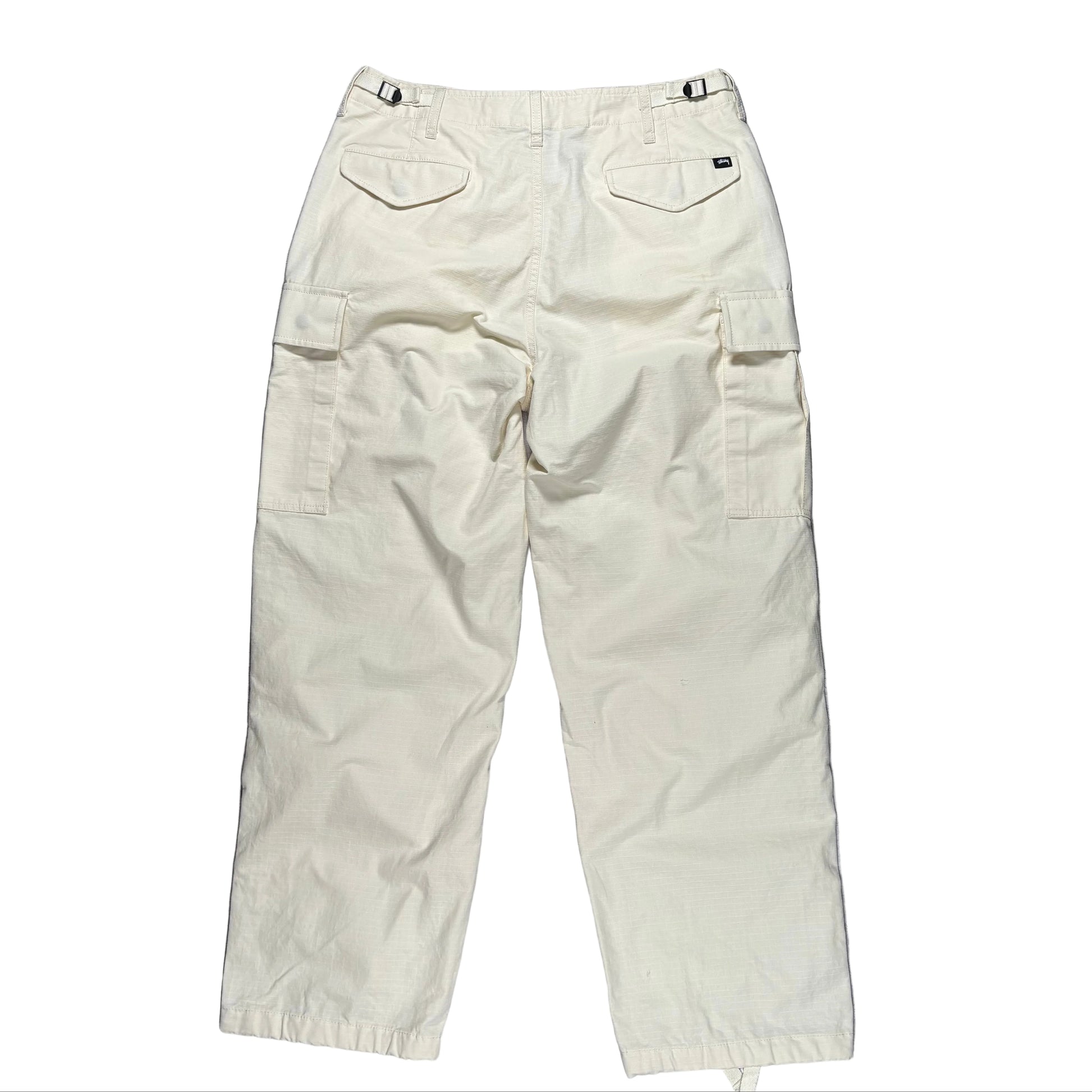 Beige cargo pants on a white surface 