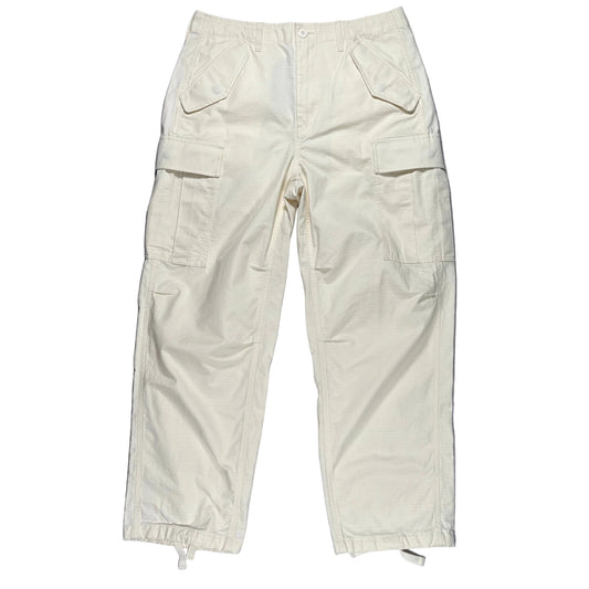 Beige cargo pants on a white surface 