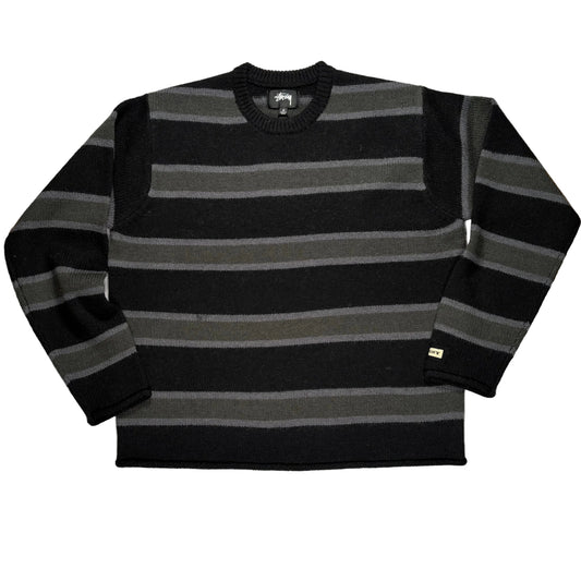 Black and gray striped sweater on a white surface