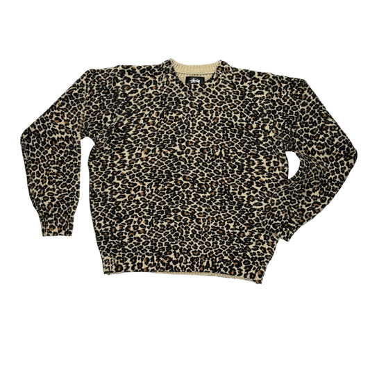 Leopard print sweater on a white surface 
