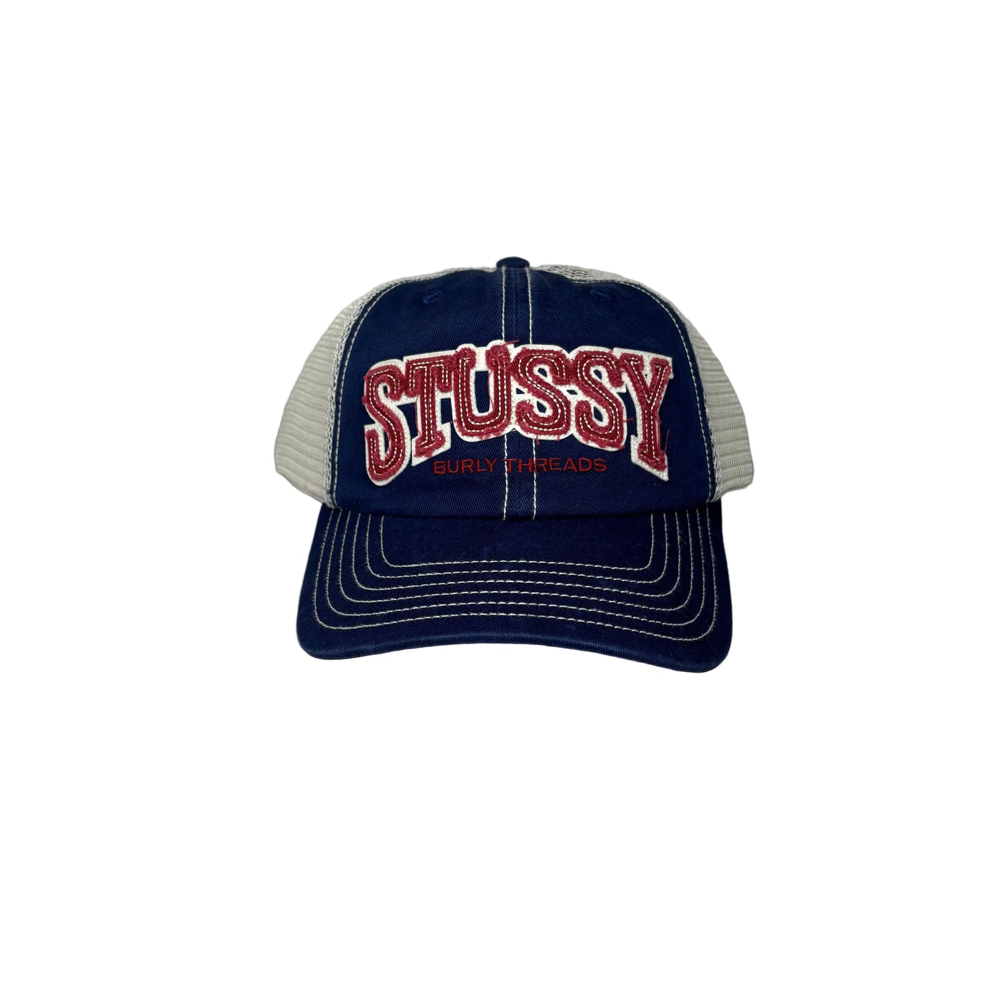Navy blue and white cap with 'Stussy' branding on a white background