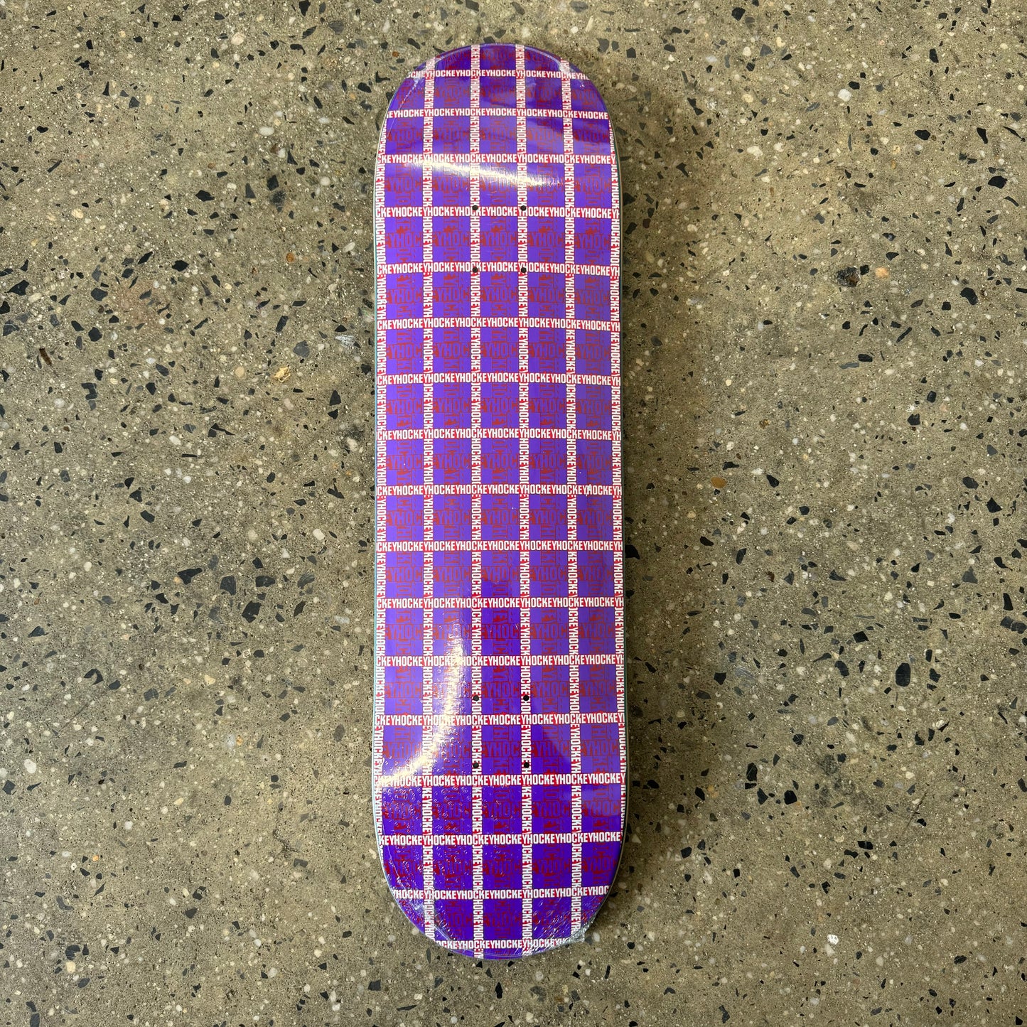 red and white plaid on purple skate deck