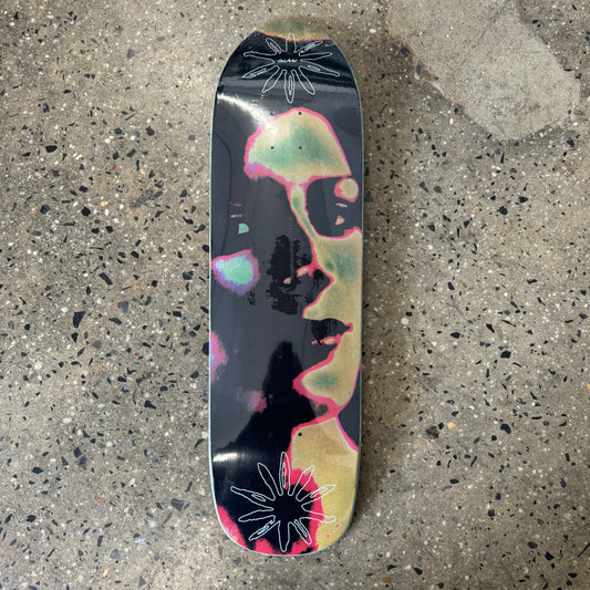 abstract face on black skate deck