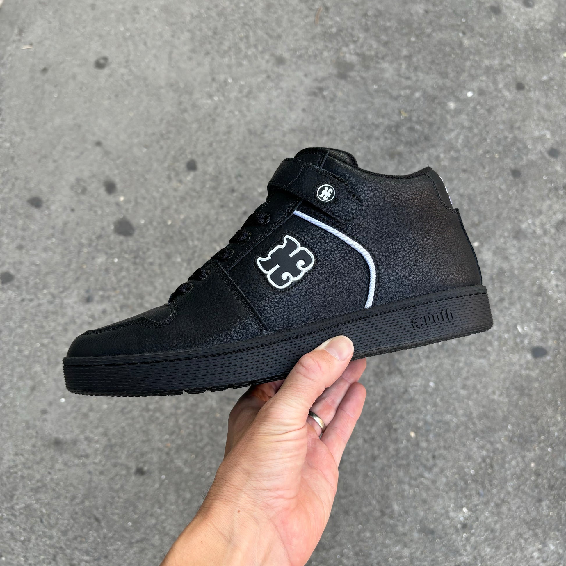 side view of high top black leather skateboard shoe