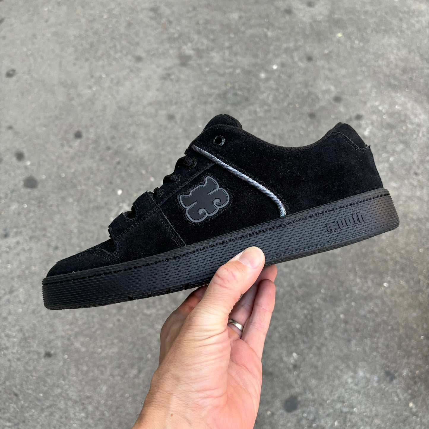 Side view of black suede skate shoe