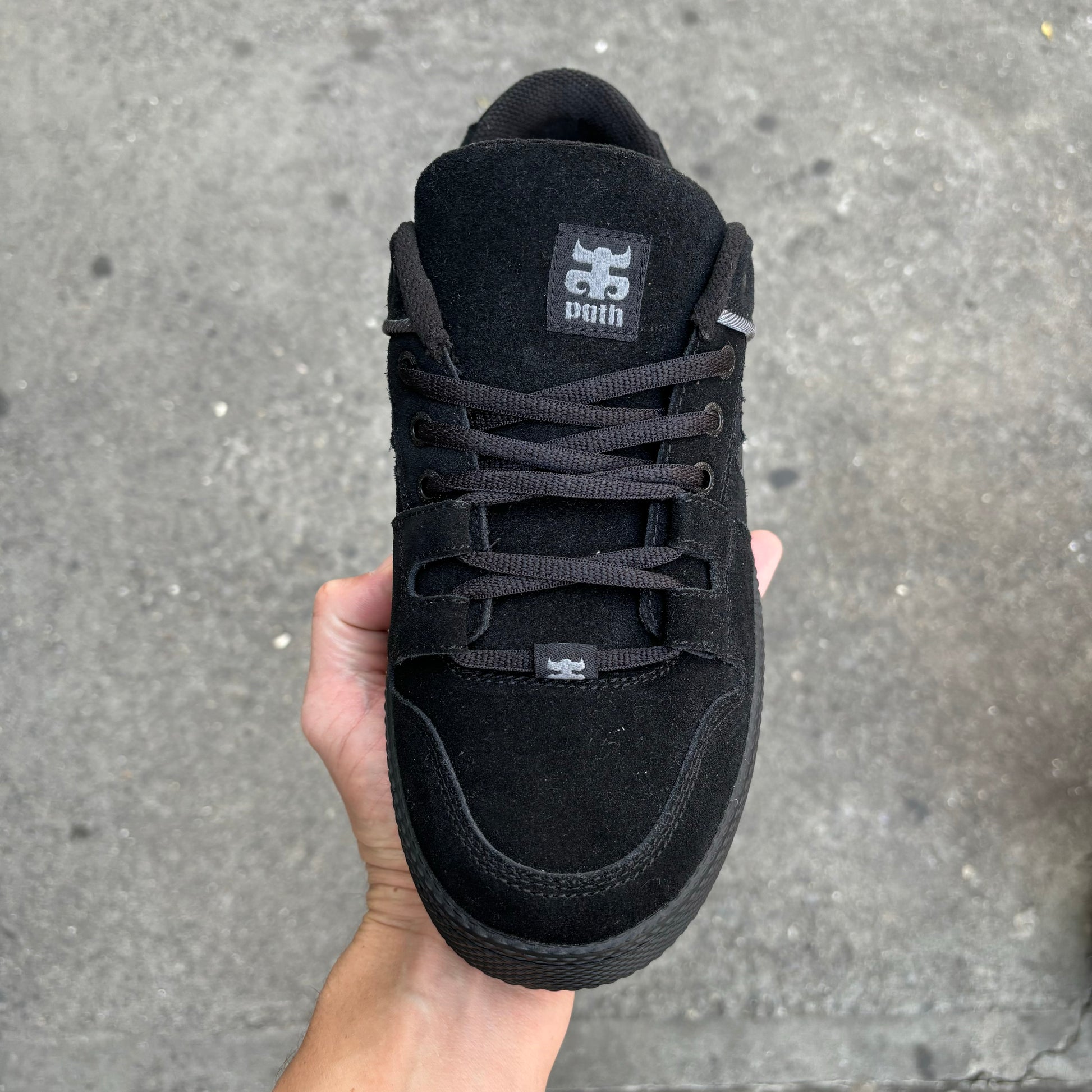 top down view of black suede shoe