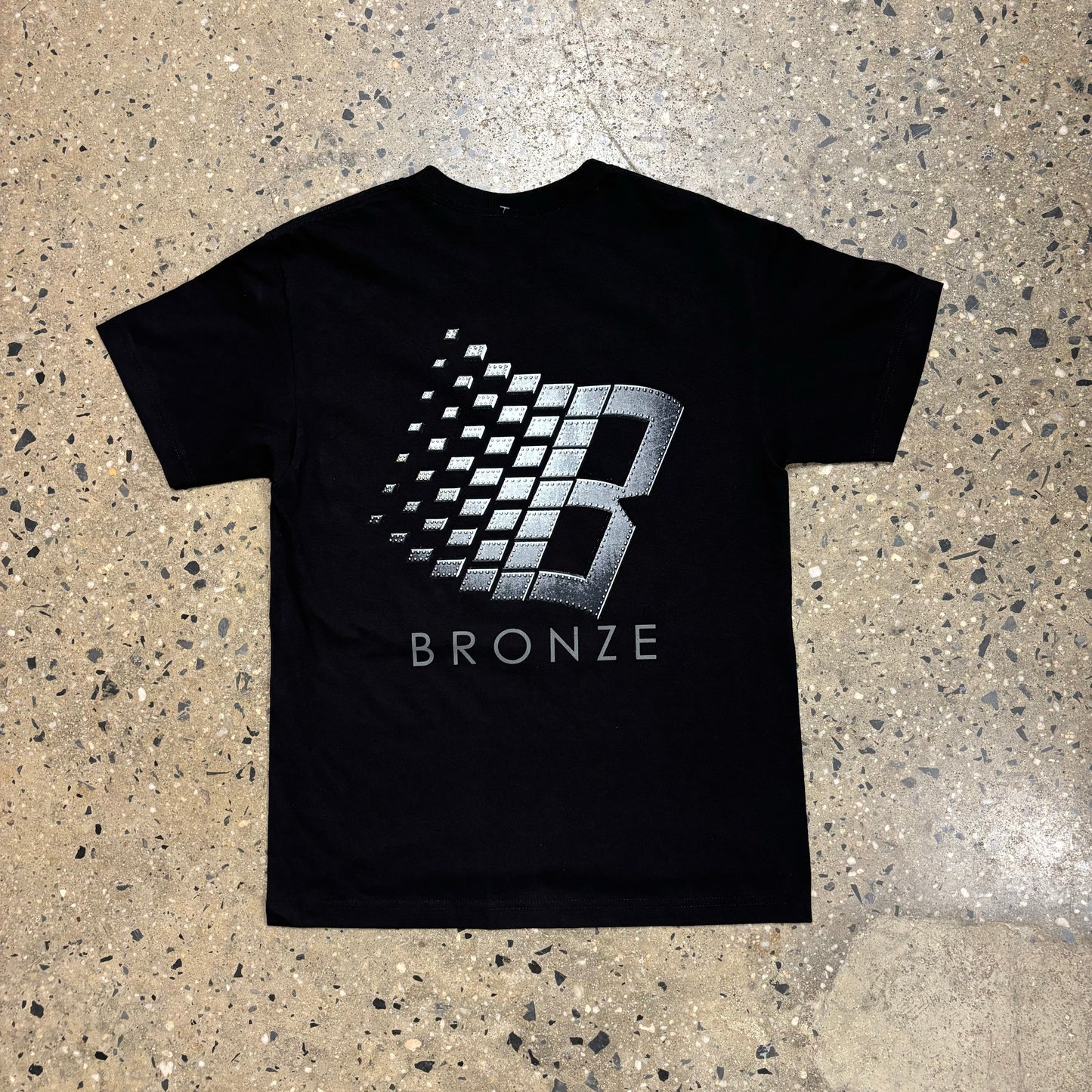 View of back of Classic B logo t-shirt from bronze, in metal bolt print