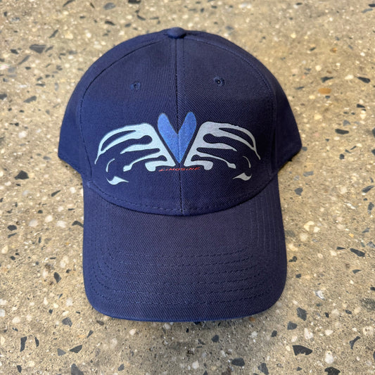 Heart and wings grey and blue printed logo on six panel hat, similar in style to one you might find in a truck stop in Ohio