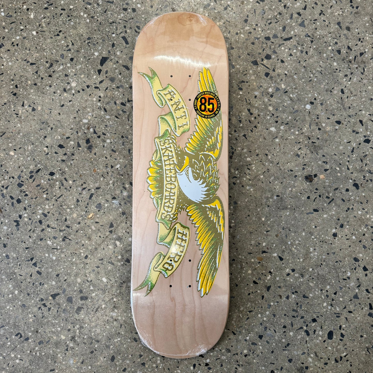 Yellow and black eagle logo with spread wings on natural woodgrain