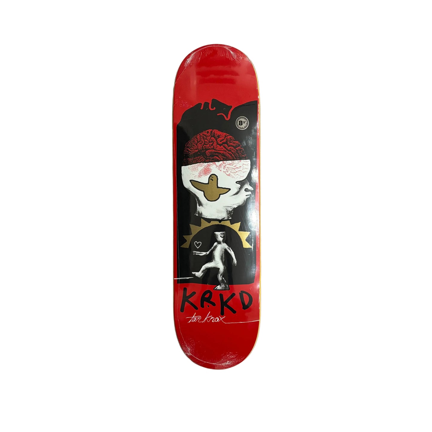 Skateboard deck with a red background and black and white graphics on a white surface.