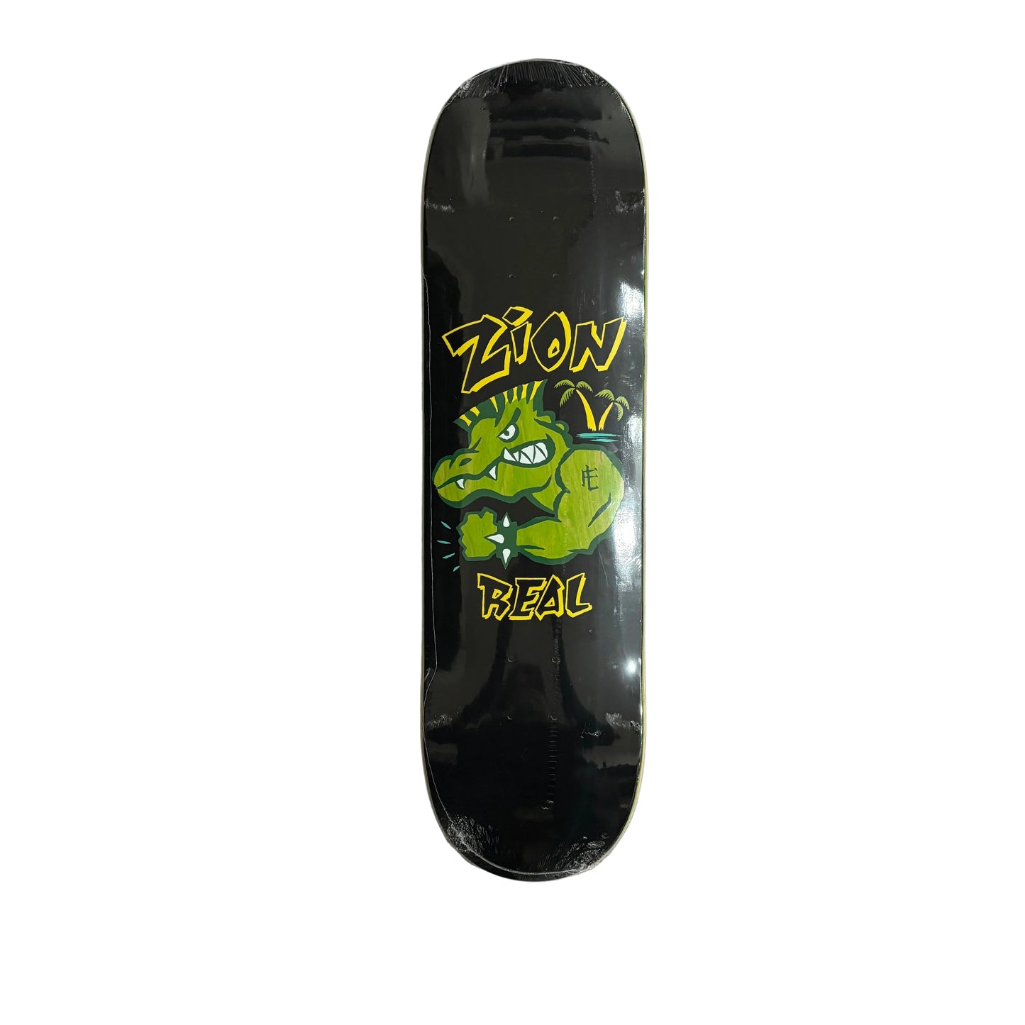 Black skateboard deck with green and yellow graphics on a white surface