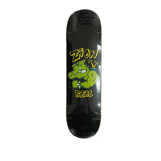 Black skateboard deck with green and yellow graphics on a white surface
