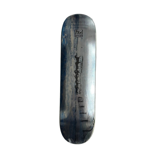 Skateboard deck with a black and white design on a gray surface