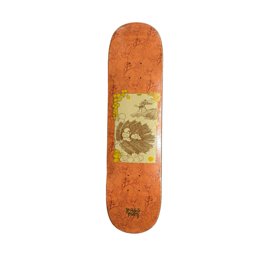 Skateboard deck with an orange floral design on a white surface