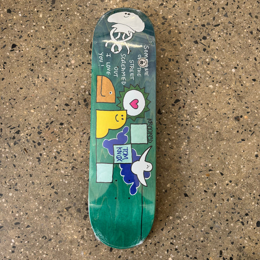 multi color characters on green wood grain skate deck (wood grain colors may vary)