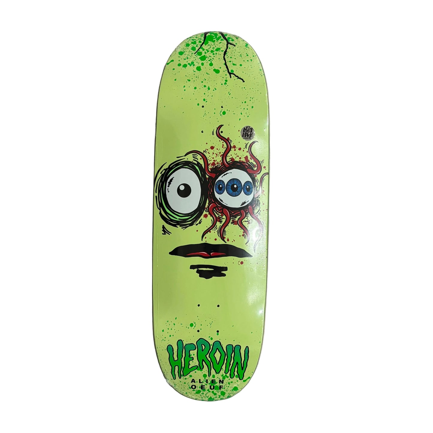 Skateboard deck with a colorful alien face design on a white surface
