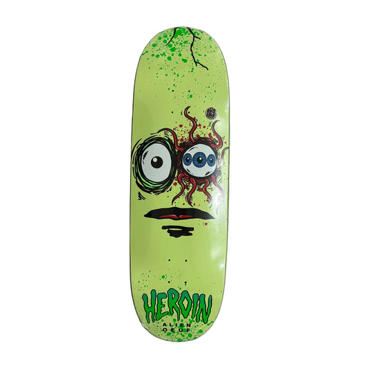 Skateboard deck with a colorful alien face design on a white surface