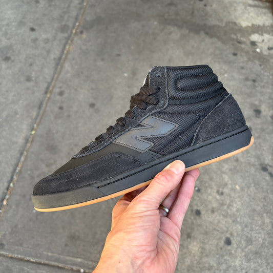 Side view of black/gum suede high top skateboard sneaker