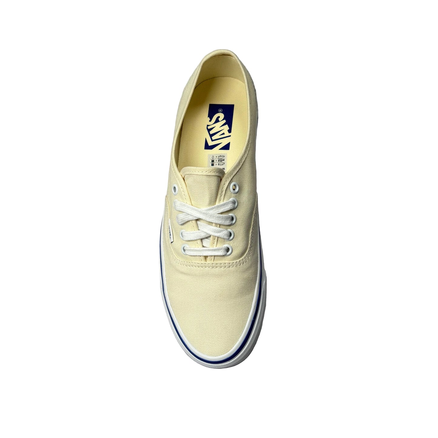 Beige sneaker with white laces on a white surface