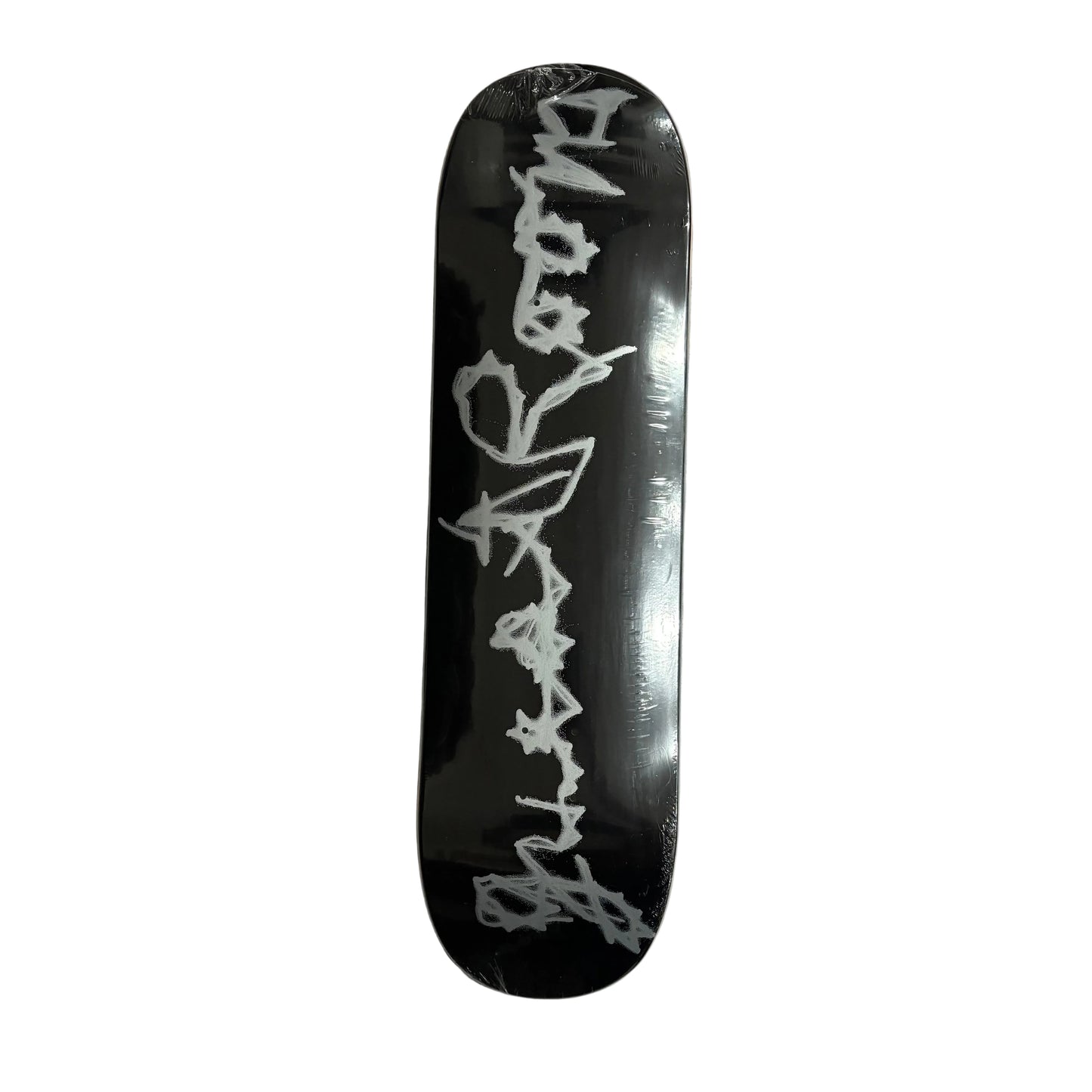 Black skateboard deck with white text on a white surface