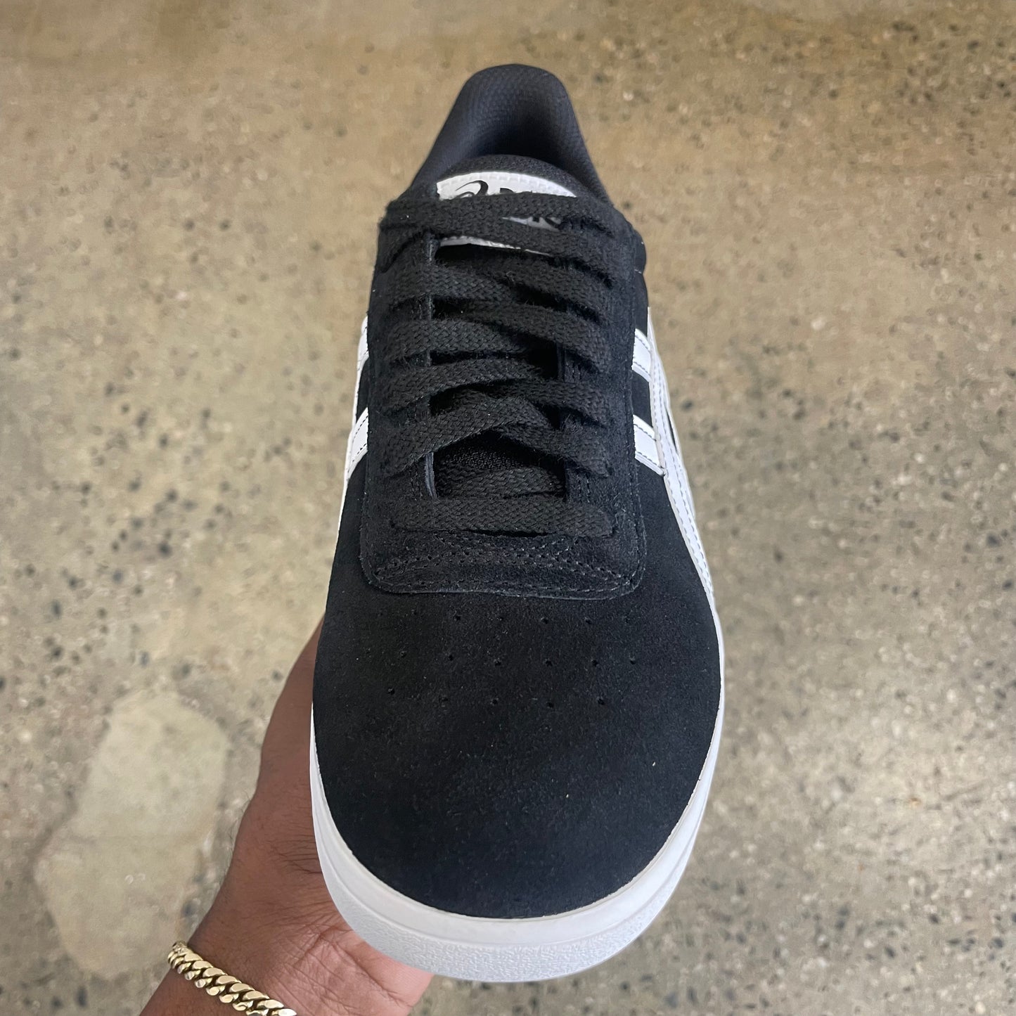 front/top down view of black/white suede skate sneaker