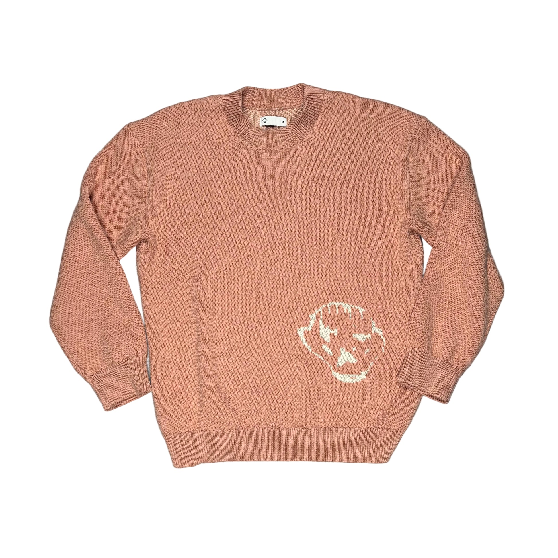 pink sweater with a white logo on a white surface