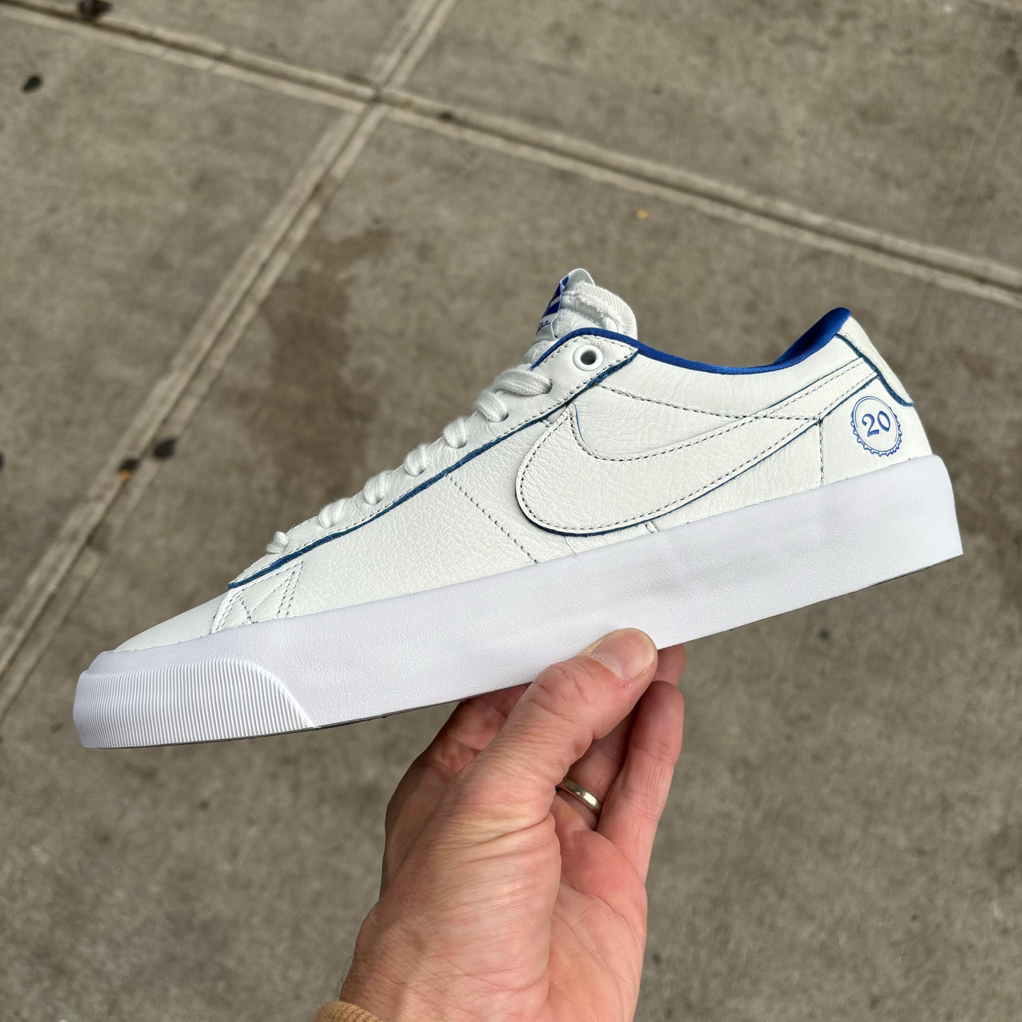 Side view of white/blue nike skate sneaker