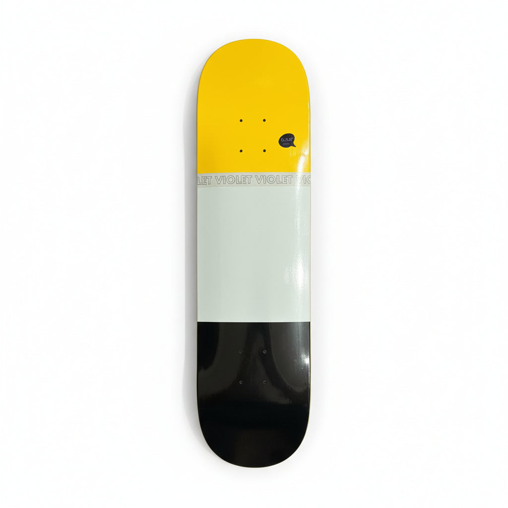 Skateboard deck with yellow, white, and black design on a white surface