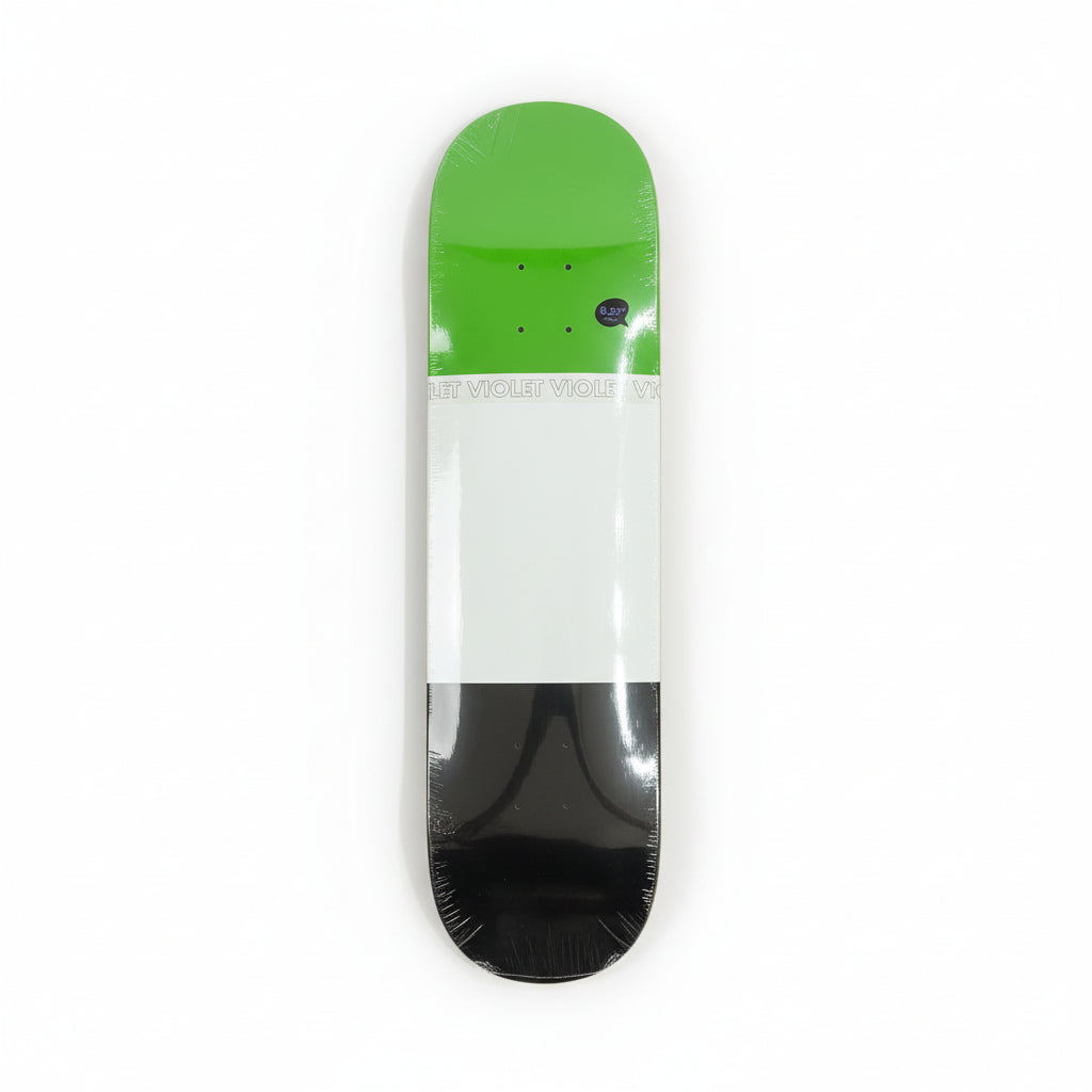 Skateboard deck with green, white, and black design on a white surface.