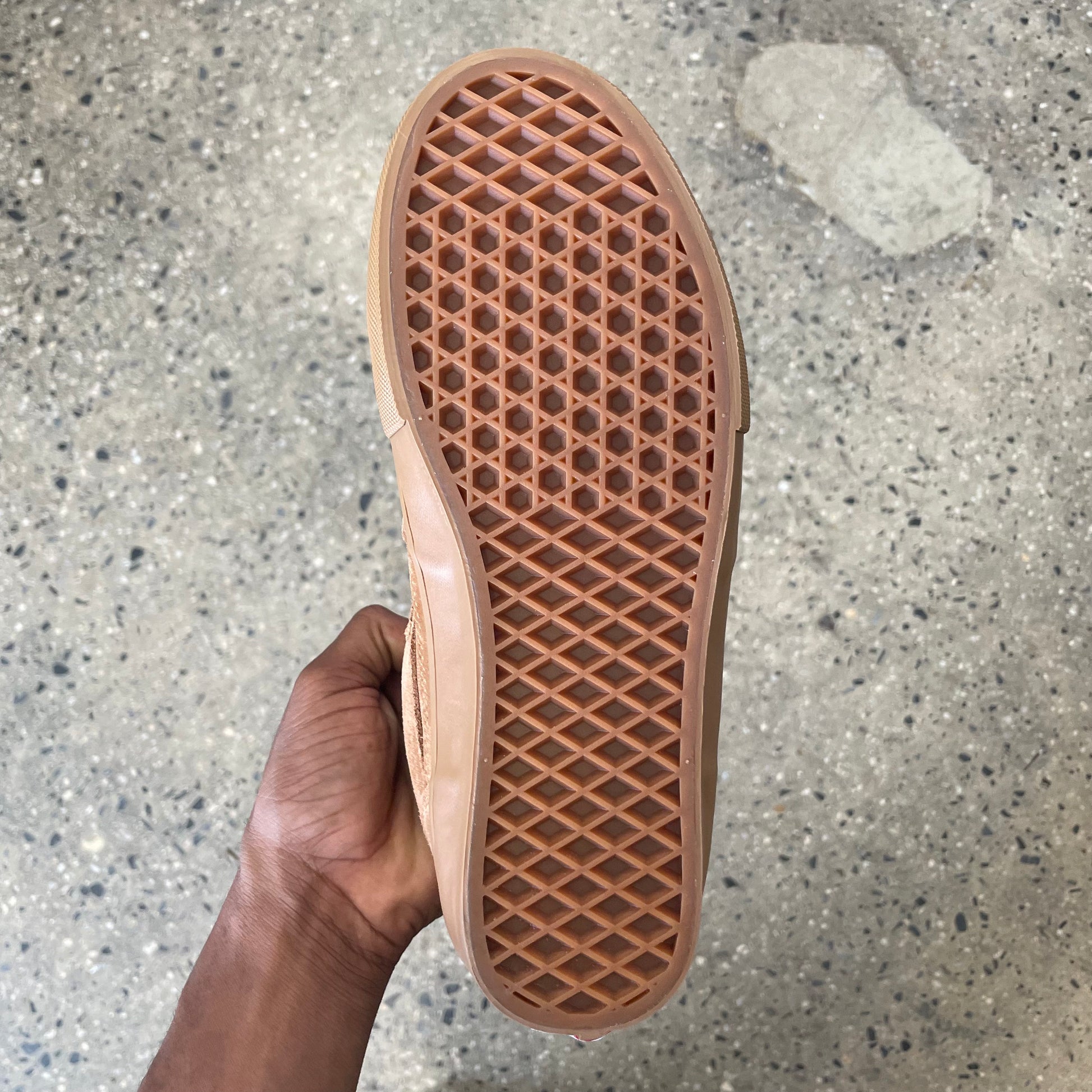 view of gum rubber sole on mid top skate shoe