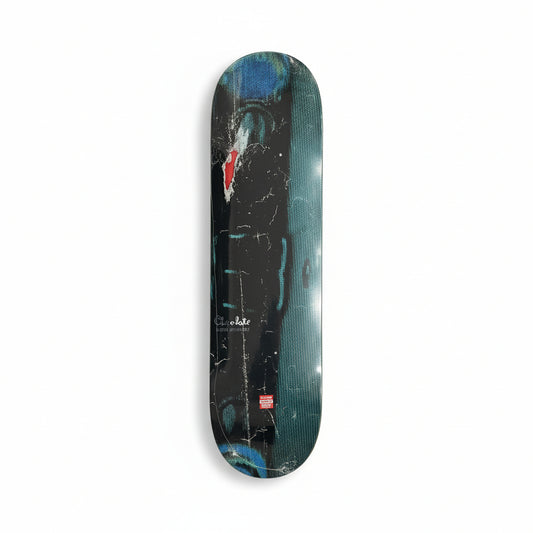Skateboard deck with a black and blue design on a white surface