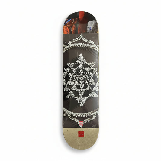 Skateboard deck with geometric design on a white surface