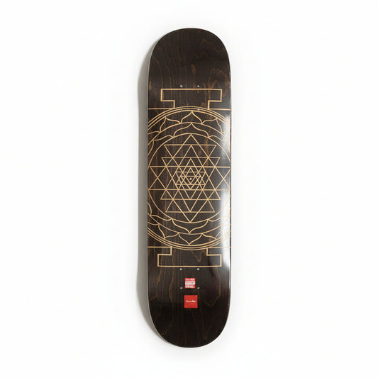 Skateboard deck with geometric mandala design on a white surface