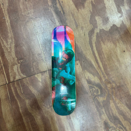 Multi Color cyber graphic of assassin with gun on skateboard deck