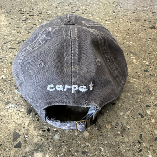 rear view of bleached denim hat with carpet logo