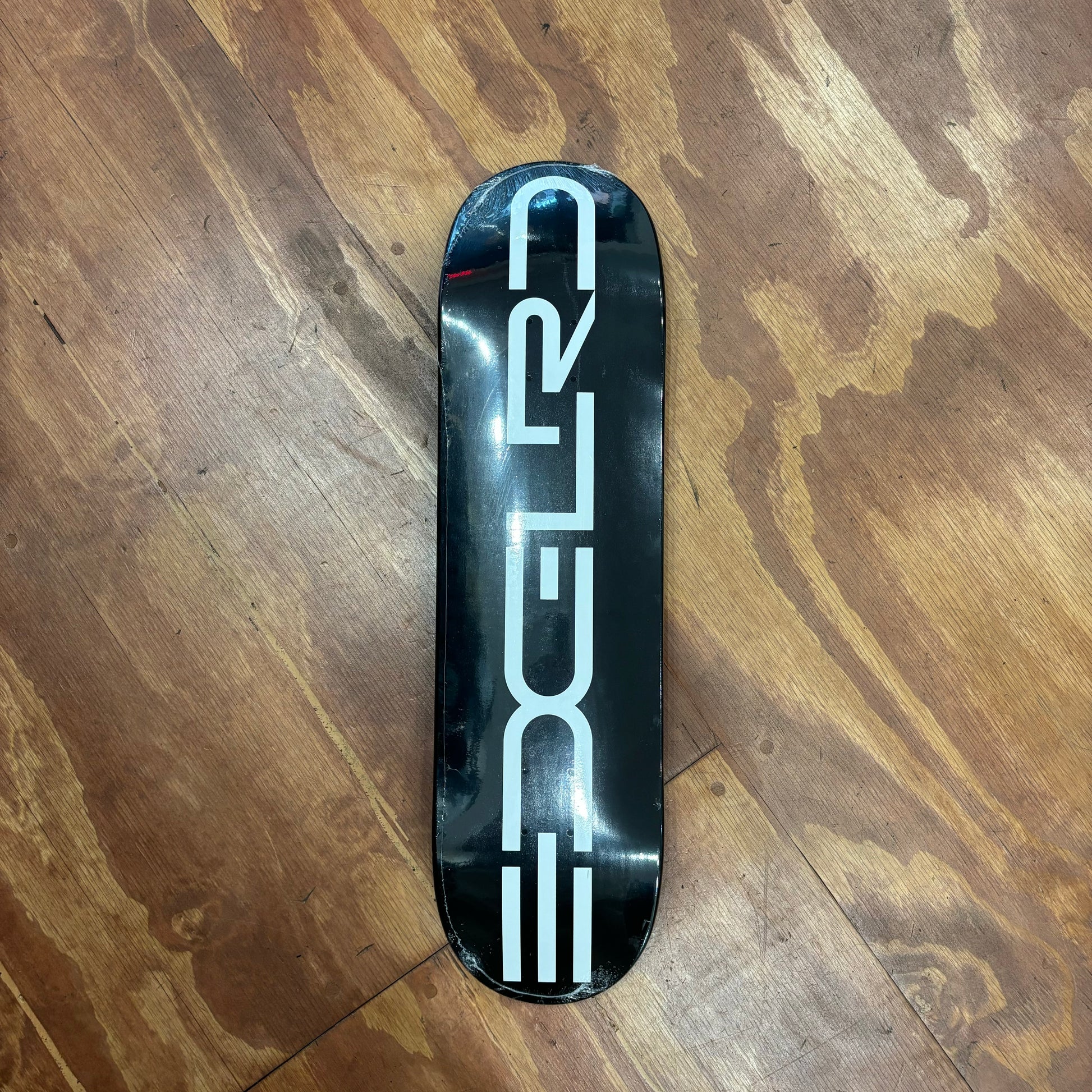 White EDGLRD graphic on black dipped skateboard deck. This is the color on the 8.38 size